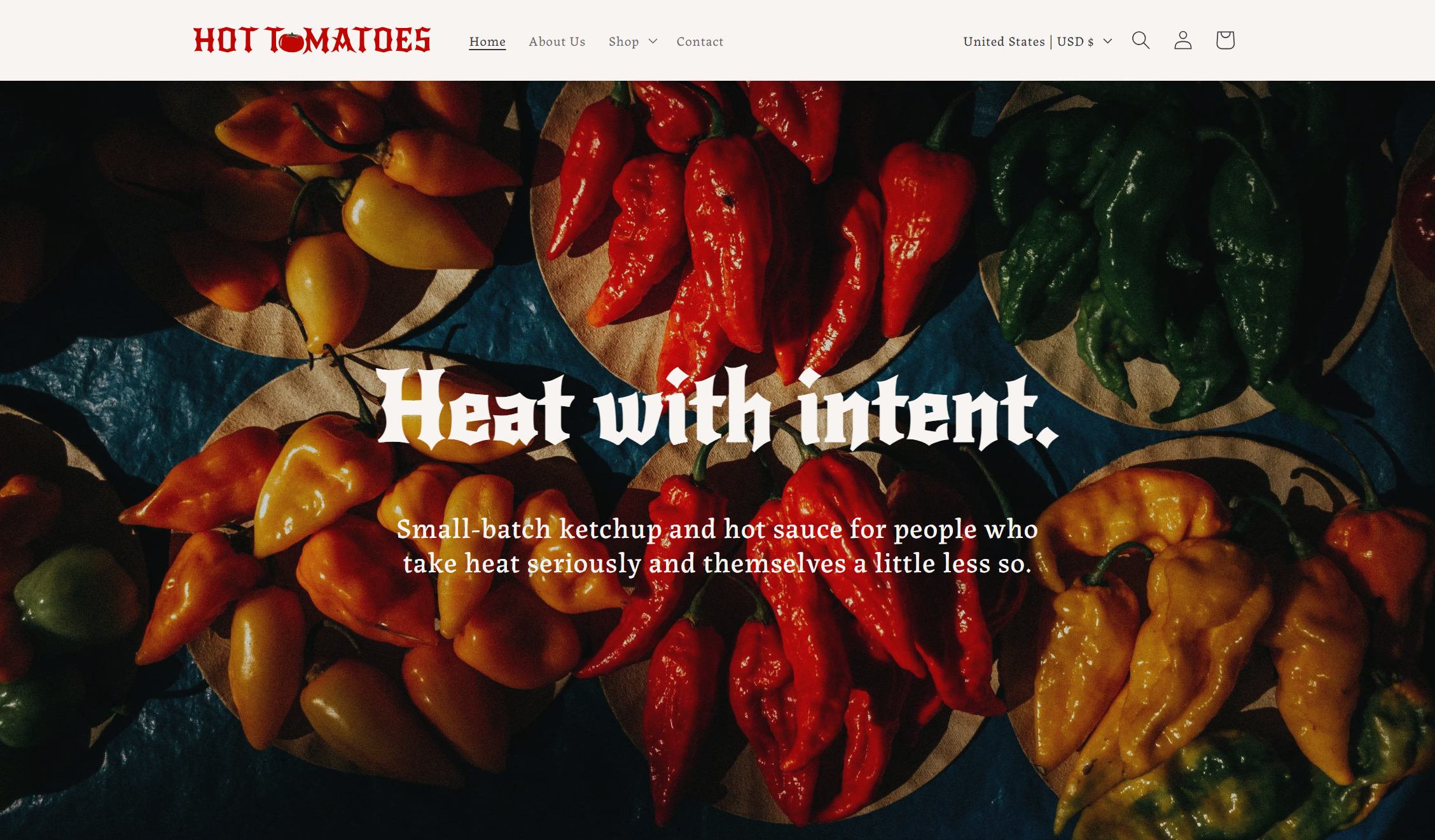 Hot Tomatoes home page, featured a parchment-colored navigation menu with the logo in the top-left corner. Below the navigation menu is an image of chili peppers, with parchment-colored text overlayed that reads: "Heat with intent." in title text, and the subtitle "Small-batch ketchup and hot sauce for people who take heat seriously and themselves a little less so."